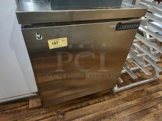 Continental 27″ commercial undercounter refrigerator, model SW27, in stainless steel. Features a sleek design, visible model label, and auction tag with lot number 157.