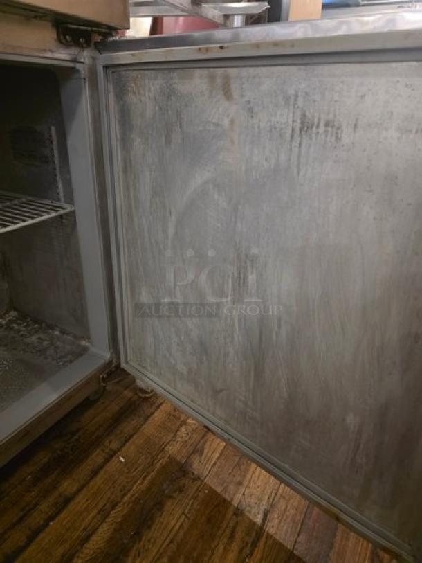Continental SW27 commercial undercounter refrigerator, 27 inches, showing interior and door; visible wear and needs cleaning.