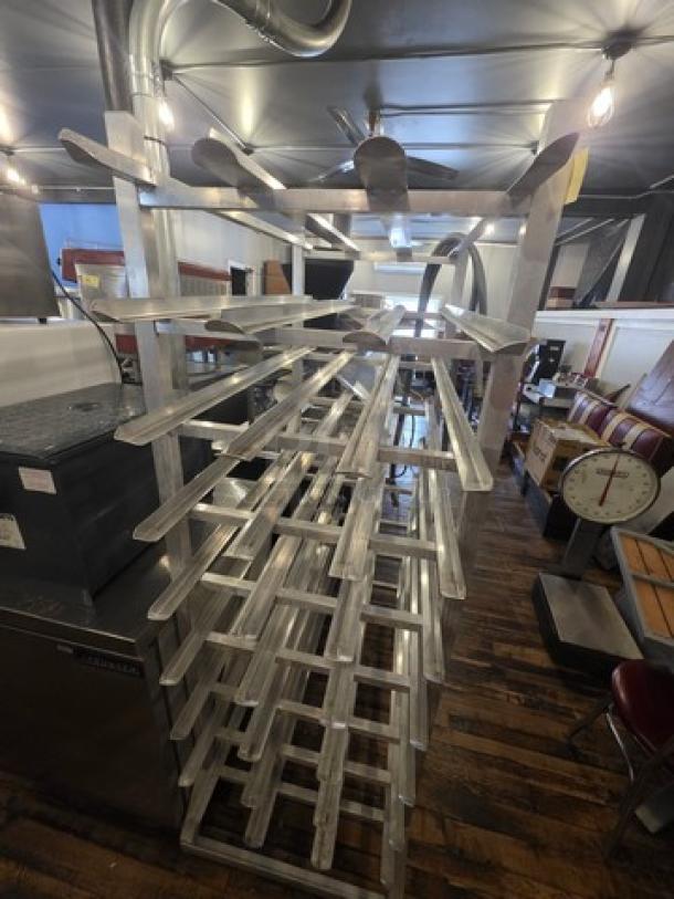 Aluminum can rack, sturdy multi-tiered design, excellent condition, ideal for storage and organization in commercial settings.