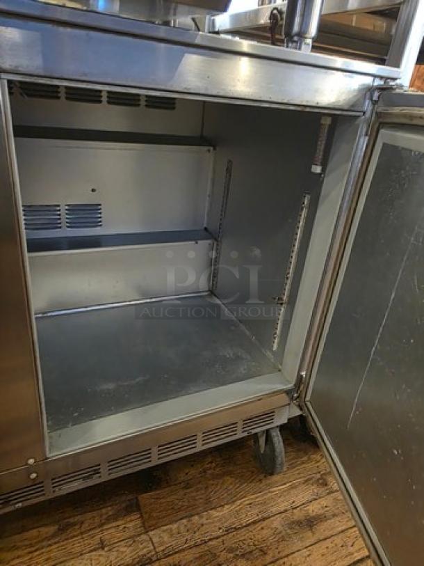 Beverage-Air UCR48A 48" undercounter refrigerator with open door showing interior shelves. Stainless steel finish, good condition.