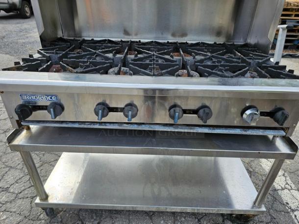 Radiance 48" 8-burner gas commercial hotplate with stand, stainless steel, used, visible wear on knobs and burners.