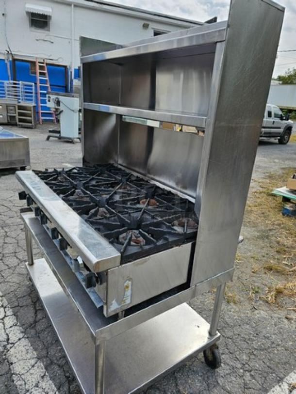 Radiance 48" gas hotplate with 8 burners on metal stand. Stainless steel, suitable for commercial use, in good condition.
