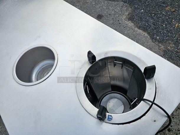 Custom stainless steel work counter with built-in warmer, features circular openings, good condition, durable material.