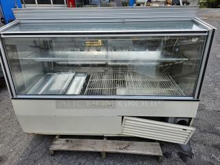 Hussmann SCD-6 Refrigerated Display Case with glass front, dual shelves, and visible wear. Ideal for commercial food display.