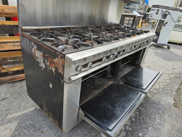 Dynamic Cooking Systems 72-12-2 natural gas range with 12 burners, two oven bases, rusted side panels, used condition.