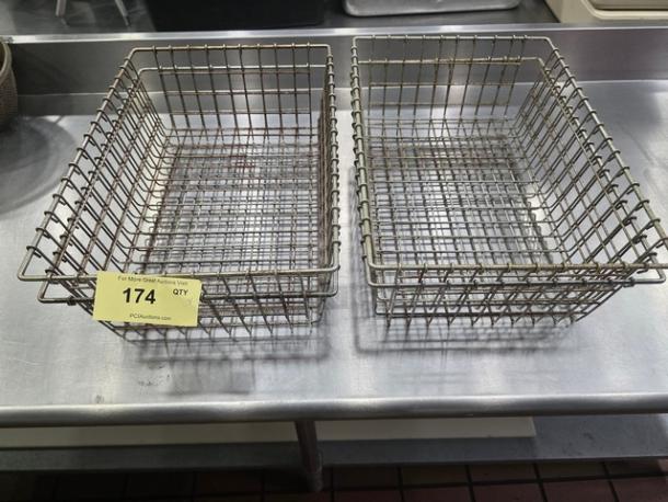 Lot of 4 metal wire baskets, rectangular shape, showing two on a stainless steel surface. Slightly rusted condition, sturdy construction. Auction tag 174 visible.