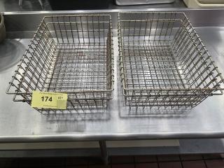 Lot of 4 metal wire baskets, rectangular shape, showing two on a stainless steel surface. Slightly rusted condition, sturdy construction. Auction tag 174 visible.