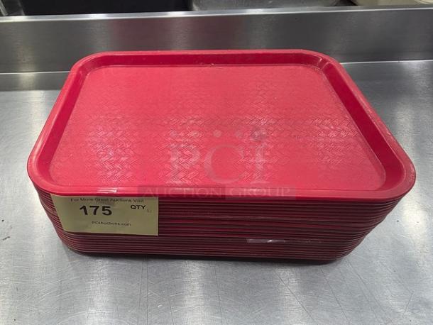Lot of 23 red plastic serving trays, textured surface, used condition. Auction label "175" visible, stackable design.