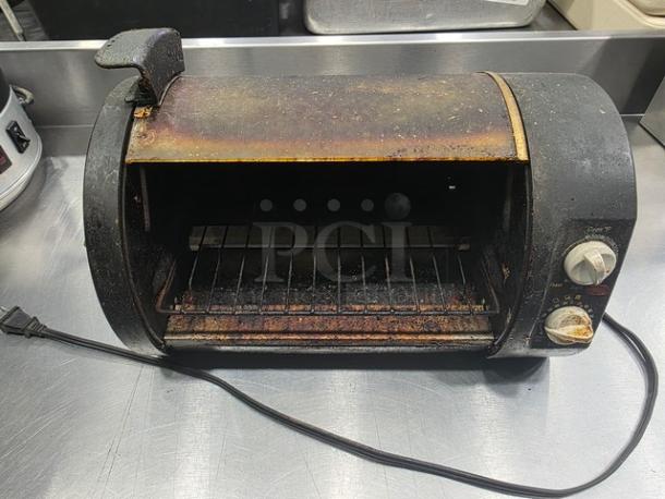 Vintage toaster oven, Model 168955, showing signs of heavy use with rust and discoloration. Visible dials, power cord attached.