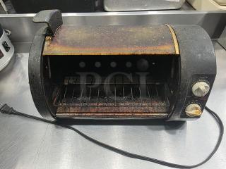 Vintage toaster oven, Model 168955, showing signs of heavy use with rust and discoloration. Visible dials, power cord attached.