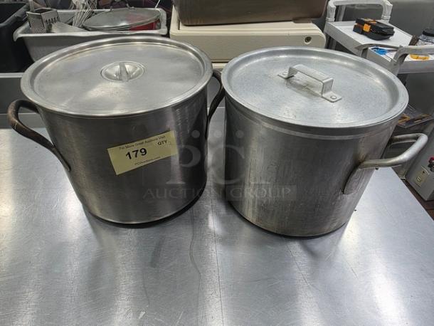 Lot of two stock pots with lids, metal construction, handles on sides. Visible wear. Label marked "179 QTY 2".