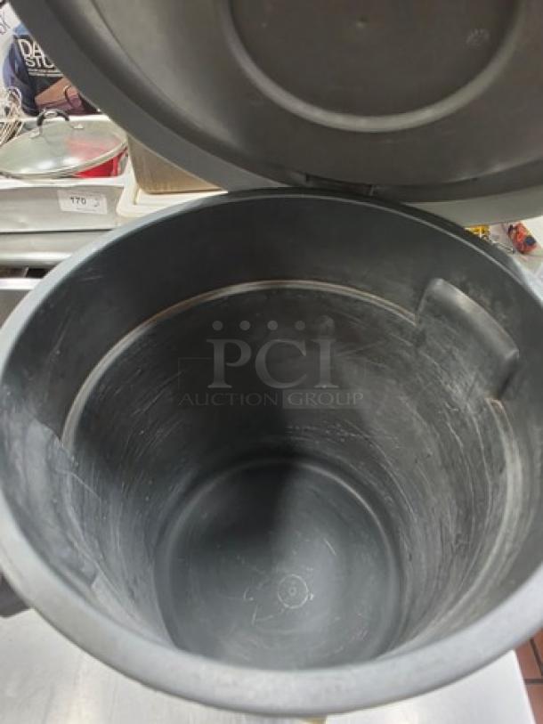 Continental Huskee 10 Gal. round receptacle with lid, black. Slight wear, sturdy plastic, ideal for versatile waste management.
