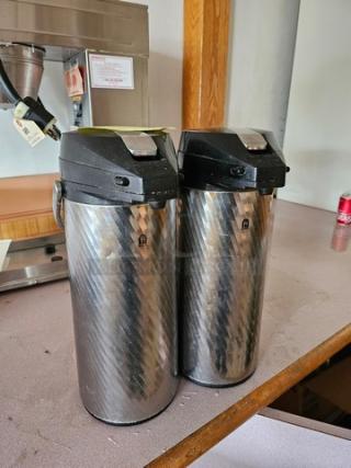 Lot of two Newco Thermal Airpots with brushed stainless steel finish. Both feature black lids, minimal wear.