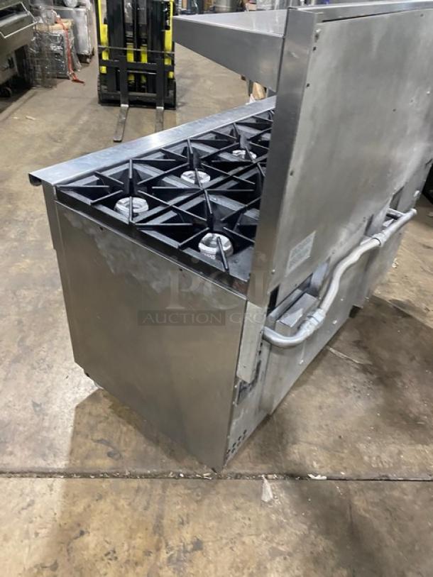 Vulcan 10-burner stainless steel range, model 60SS-10BN. Features double oven, backsplash, salamander shelf, and casters.