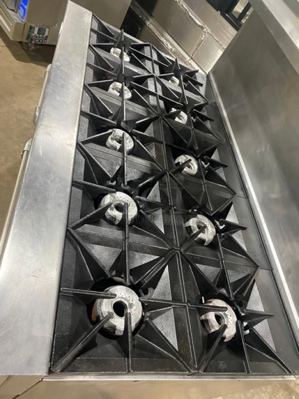 Vulcan 10-burner stainless steel range with double oven, backsplash, and overhead salamander shelf. Model 60SS-10BN, on casters.