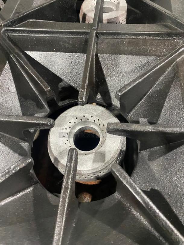 Vulcan 10-burner range close-up showing heavy-duty cast iron grates. Model 60SS10BN, features durable construction.