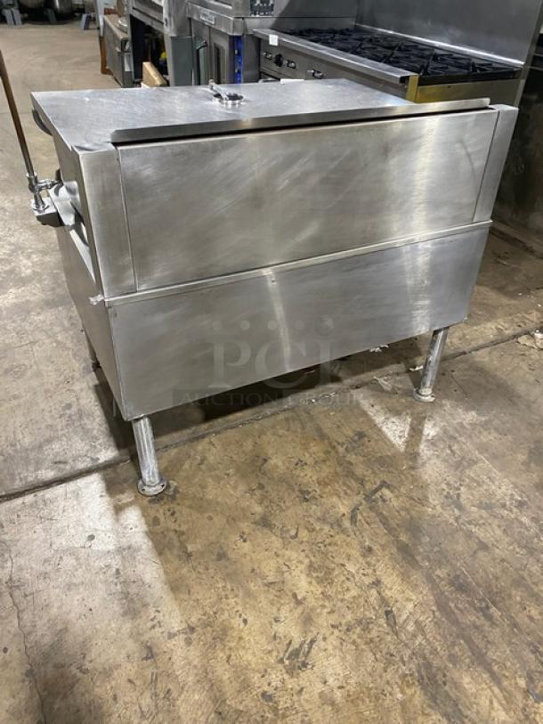 Commercial stainless steel electric-powered tilted braising pan with swivel faucet, on sturdy legs, in good condition.