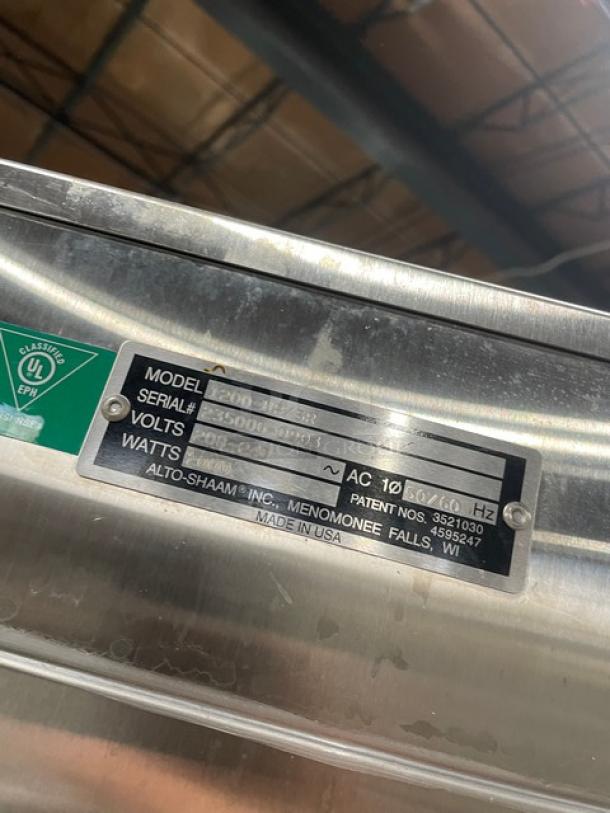 Alto-Shaam 1200-UP/SR commercial stainless steel heated cabinet, model and serial number plaque visible.