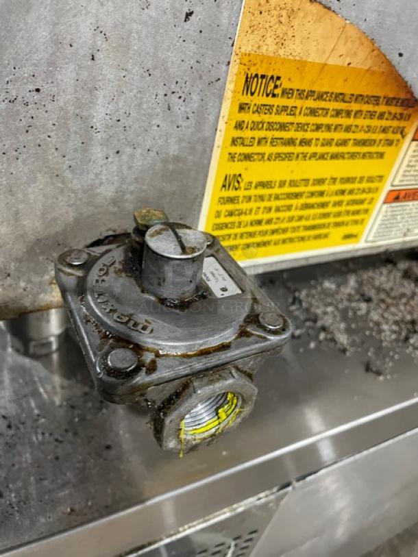 Wolf commercial stainless steel natural gas flat griddle, countertop model with back and side splash, on legs, used condition.