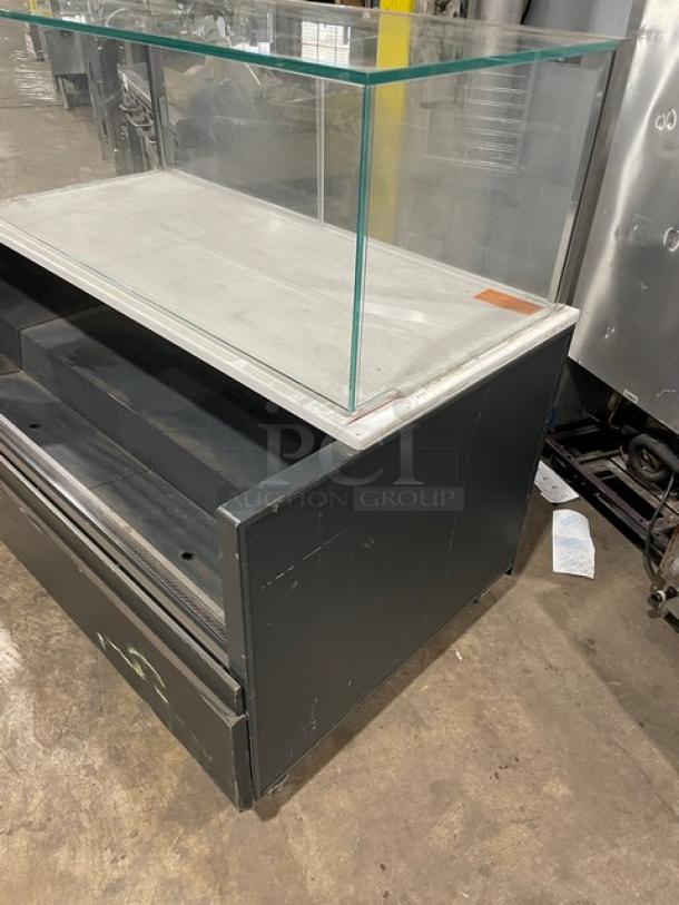 Structural Concepts black multi-level refrigerated grab-n-go display case, Starbucks style, with glass top showcase, on legs.