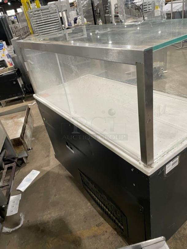 Structural Concepts commercial black multi-level refrigerated open merchandiser display case with top enclosed-glass showcase on legs.