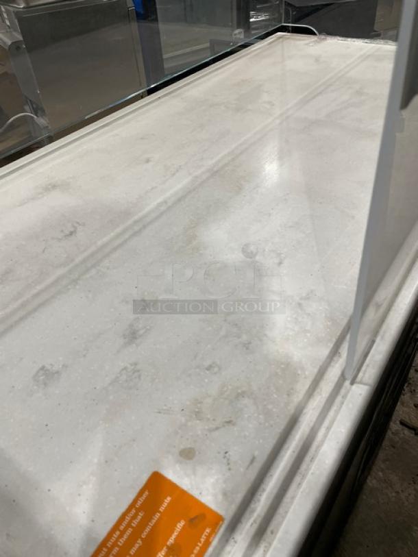 Structural Concepts black refrigerated merchandiser display case with top enclosed-glass showcase, on legs, multi-level.