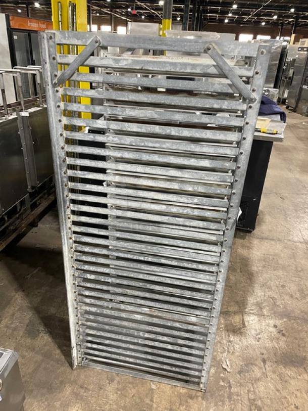 Commercial heavy-duty pan holding rack, metal construction, vertical slots, used condition, suitable for catering or kitchen use.
