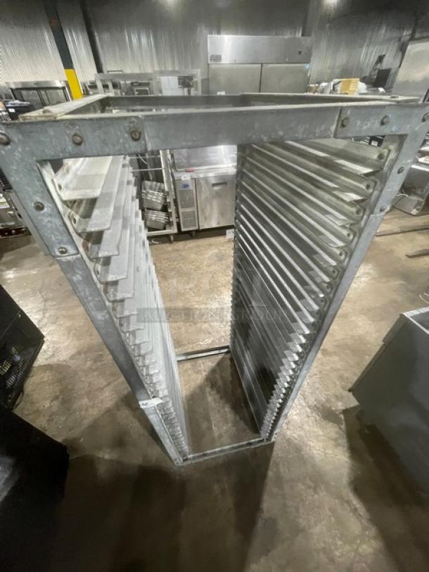 Commercial heavy duty pan holding rack, metal construction, multiple slots, used condition, suitable for industrial kitchens.