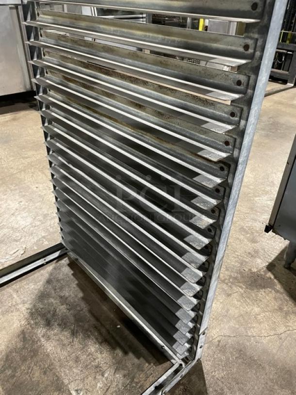 Commercial heavy-duty pan holding rack with multiple slots, sturdy metal construction, used condition, ideal for kitchen storage.