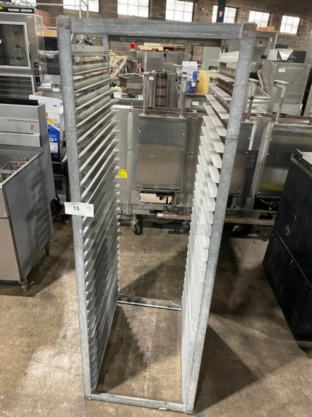 Commercial heavy-duty pan holding rack with multiple slots for pan storage. Metal construction, good condition, numbered tag 15.