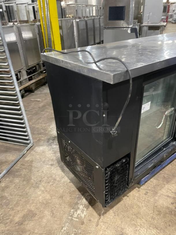 True TBB-60G-SD black double-glass sliding door back bar refrigerator with stainless steel worktop, 115V, visible wiring and ventilation.