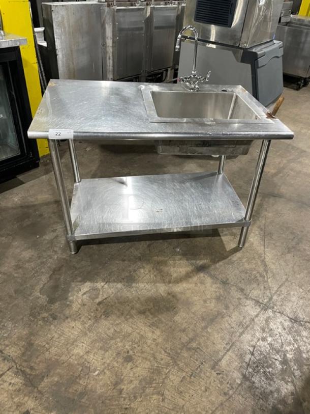 Commercial stainless steel single-compartment sink with gooseneck swivel faucet, undershelf, and legs. Good condition.