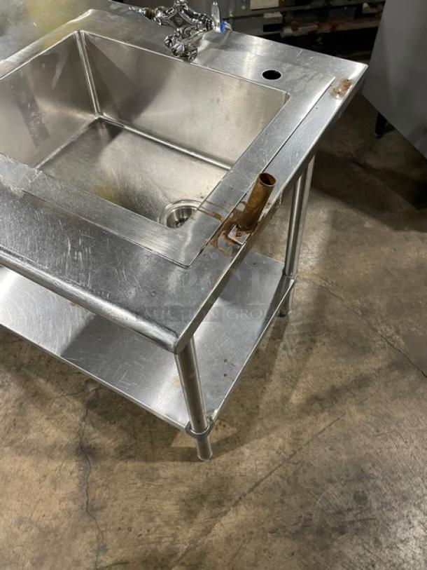 Commercial stainless steel hand wash/prep sink with gooseneck swivel faucet, single undershelf, and legs; used condition.