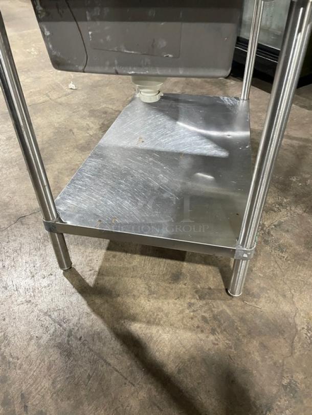 Stainless steel single-compartment sink with gooseneck faucet, metal undershelf, sturdy legs, suitable for commercial use.