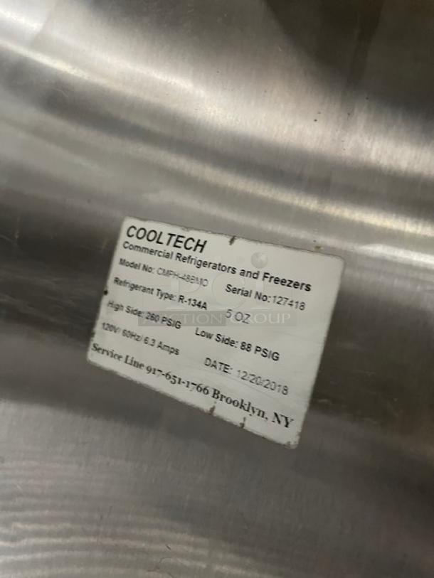 CoolTech CMPH-48BMO stainless steel refrigerated prep table, 2 doors, chrome wire rack, model/serial info tag visible.