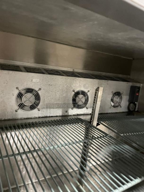 Leader NSFB48SC undercounter refrigerator interior, showing poly-coated wired rack and cooling fans. In good condition.