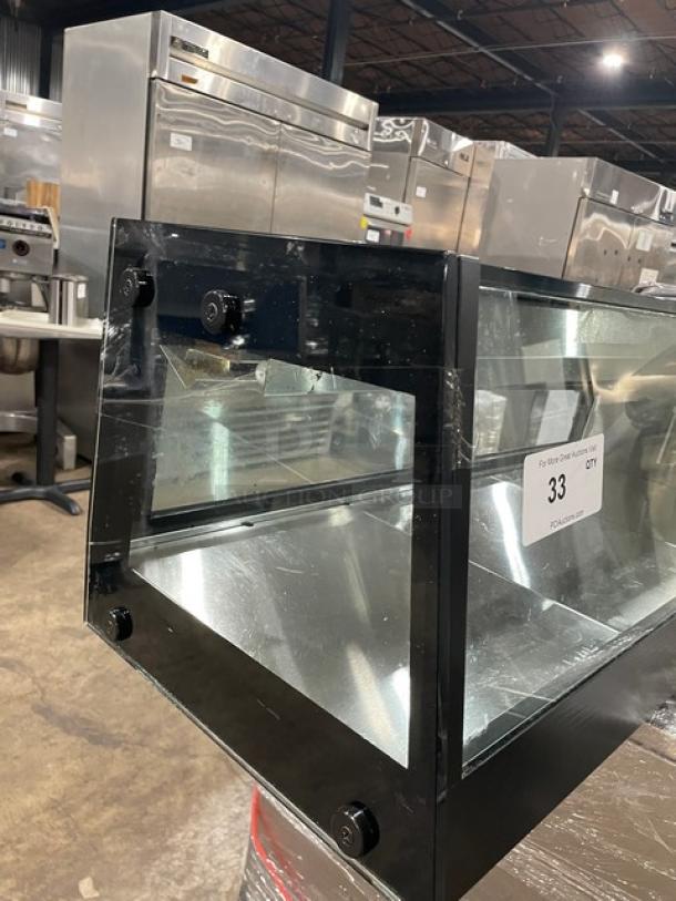 Turbo Air black refrigerated sushi display, stainless interior, rear sliding doors, SN: H2SAS50D1024, excellent condition.