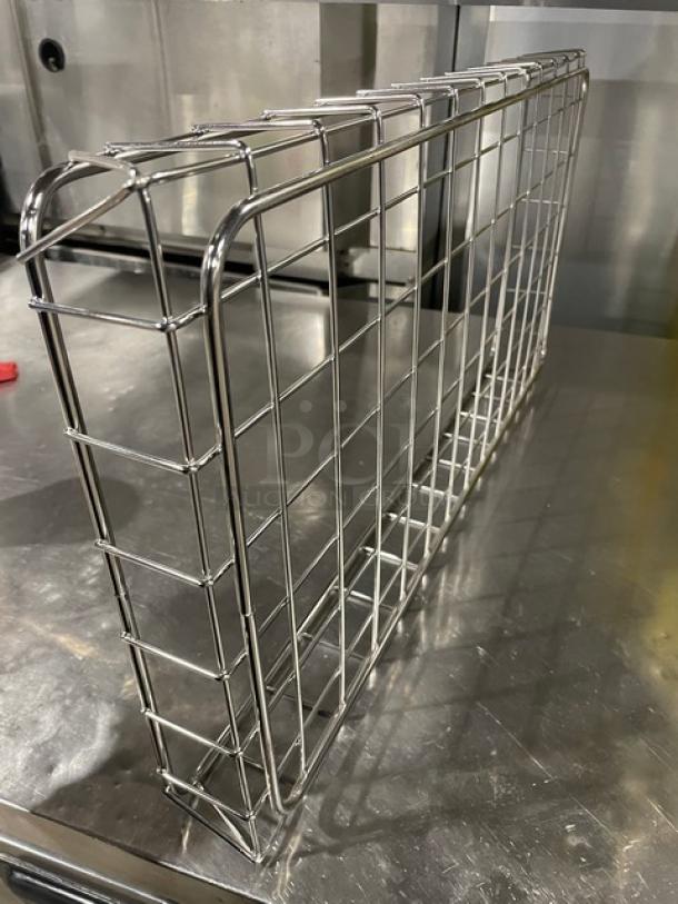 Commercial chrome-plated full-sized wire rack for bagels or pastries, in excellent condition, on a stainless surface.