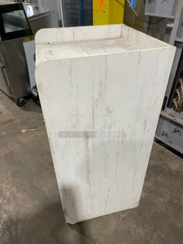 Commercial wooden enclosed-style waste receptacle cabinet, whitewashed finish, sturdy construction, minor wear visible.
