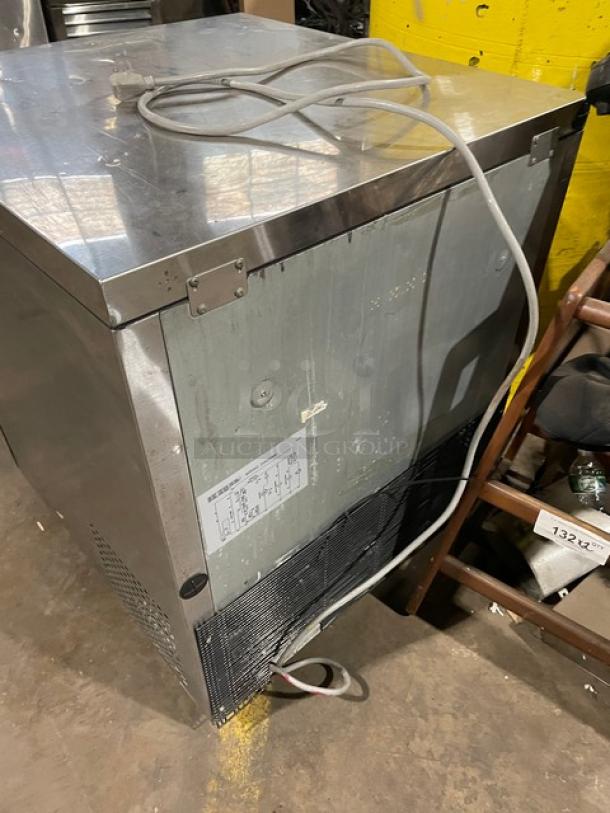 True TUF-28SD commercial stainless steel undercounter freezer with poly coated wired rack, 115V, on casters.