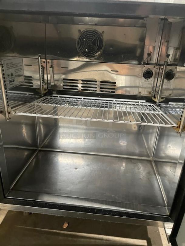 True TUF-28SD stainless steel undercounter worktop freezer with poly-coated rack, 115V, on casters, commercial use.