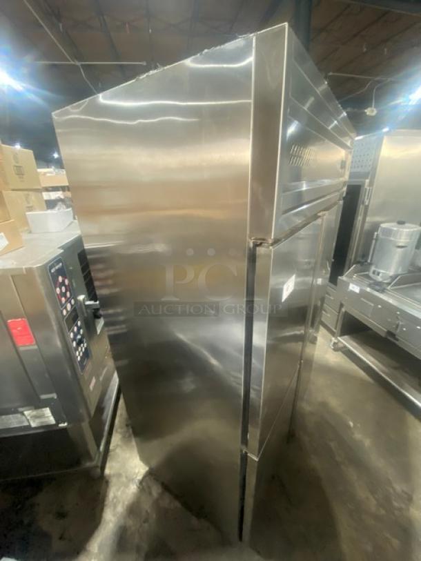 Commercial stainless steel double half-door reach-in refrigerator, with poly coated wired rack, on casters, excellent condition.