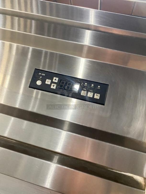 Commercial stainless steel double half-door reach-in refrigerator with digital display, on casters, includes poly-coated wired rack.