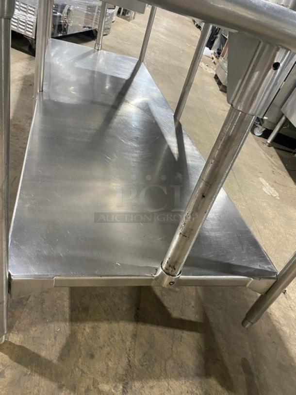 Commercial stainless steel worktop table with undershelf, overhead rack, and pull-out drawer. Excellent condition.
