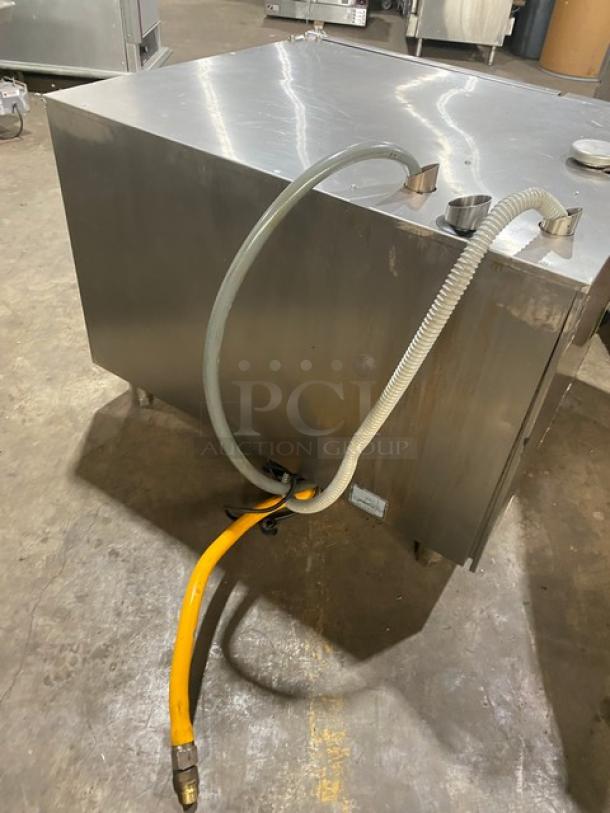 Rational SCCWE62G combi oven, stainless steel, natural gas, 6-pan, Energy Star, yellow gas hose, 208V 1-phase, on legs.