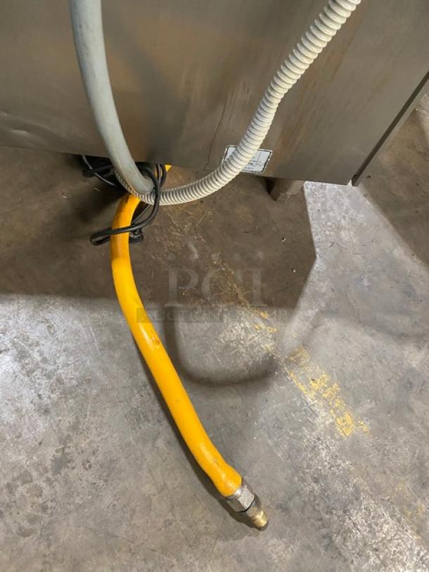 Rational Self Cooking Center SCCWE62G, stainless steel, natural gas, 6-pan combi oven, Energy Star, yellow gas hose, on legs.