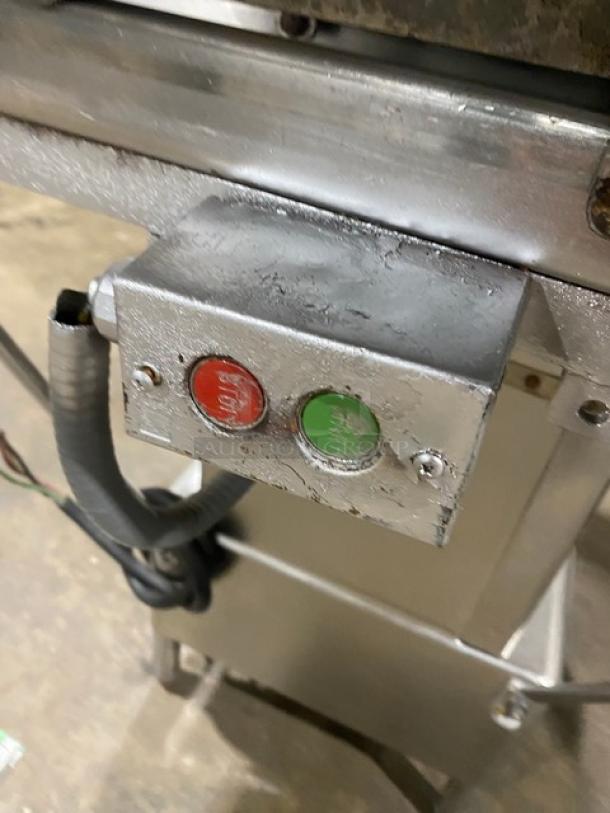 Butcher Boy stainless steel electric meat band saw, free-standing on legs, with start/stop buttons, in used condition.