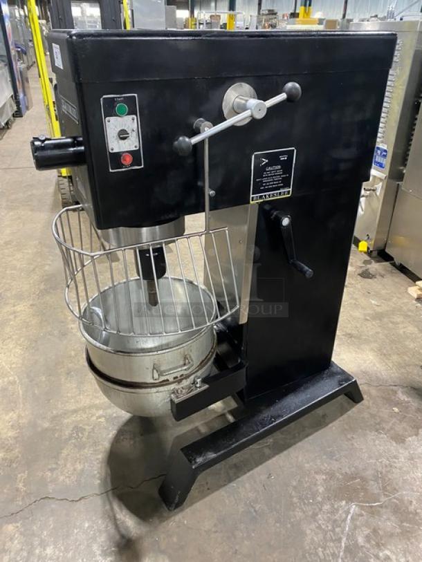 Blakeslee commercial black electric planetary mixer with stainless steel bowl guard, mixing bowl, and spiral hook attachment.