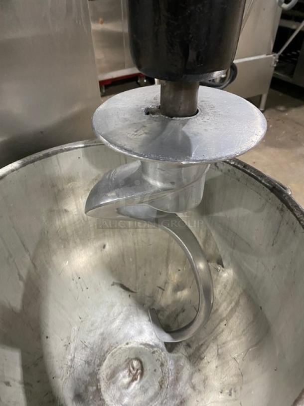 Blakeslee commercial black electric planetary mixer with stainless steel bowl guard, mixing bowl, and spiral hook attachment.