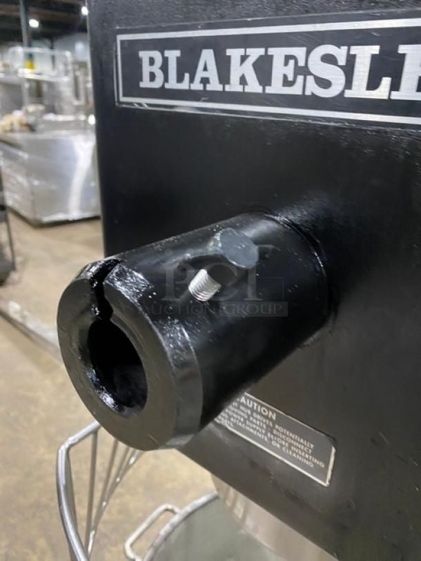 Blakeslee commercial black electric planetary mixer with stainless bowl guard, mixing bowl, and spiral hook attachment.